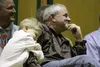 Bridger Hursh, age 7, hugs his father, Martin Hursh, as he listens to commendations from fellow Colony Middle School teacher Steve Mann at a retirement celebration on Thursday, Dec. 17. Hursh