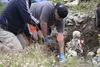Josh Kimpton with the state Medical Examiner’s office works Tuesday to exhume a skeleton instructors planted at a gravesite mock-up in the field behind Mat-Su Regional Medical Center. Kimpton
