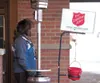 Salvation Army bell ringer Starla Hargis stands near the
Wal-Mart entrace Monday afternoon in Wasilla. (ROBERT
DeBERRY/Frontiersman) Robert DeBerry
