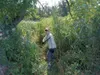 Tech. Sgt. Kinga Cummings, 303rd Intelligence Squadron, poses with a machete in Poland, July 2022. She is on a Defense POW/MIA Accounting Agency investigative team who must face a myriad of t