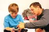 Sam Allred and Andrew Kurka look at photos of the rods and cable zip ties Kurka has rigged to enable him to drive without using his legs.The two were injured in separate all-terrain vehicle a