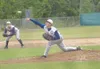 MATT TUNSETH/Frontiersman Alaska Road Warriors pitcher Wes Smith
delivers to home plate Wednesday as third baseman Colter Peterson
looks on during the Road Warriors' 11-1 win over Bartlett at