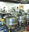 Large stainless steel kettles hold gallons of hot barbecue sauce
at the Mat-Su Borough School District's central kitchen. Originally
designed to handle about 3,000 lunches per day, the kitche