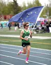 Colony's Matthew Rongitsch runs with the Alaska flag after winning on of his three individual titles at the 2023 state meet. Bruce Eggleston/matsusports.net