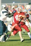 ROBERT DeBERRY/Frontiersman Wasilla Warrior Beebo Russel breaks
through Eagle River's defense Friday at Anchorage Football Stadium
Friday. The Warriors won the season opener 41-6.