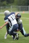 Soldotna defensive back Shane Tachick and linebacker Tyler
Cameron tackle Colony quarterback Rhett Magner on a sweep to the
right side of the field during the second quarter of Colony's 41-0
