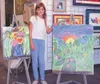 Kaitlin Henry, 10, shows off some of her acrylic paintings.
Henry and her family have traveled the world, and she draws on her
experiences for her art. Submitted photo.