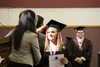 Alaska JobCorps center director Malyn Smith adjusts the tassel from one side of student Danielle Doshen's mortarboard to the other during the commencement exercises Friday in Palmer. Doshen w