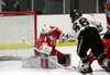 Wasilla goalie Aaron Campbell reaches out with his stick as Colony's Dane Jellich crashes the net during Colony's 3-2 win over the Warriors Friday, Jan. 26, 2018, at the Menard Arena in Wasil