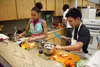 LeSedra Williams and Aden Hershman prepare their meal consisting of mayo crusted chicken, a Greek salad and fruit salad. Jacob Mann/Frontiersman