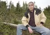 Charles Lone Wolf sits on a downed tree along Chickaloon Road. Lone Wolf is in a battle to slow truck traffic in the area. ROBERT DeBERRY/Frontiersman