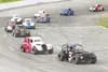 Matt Tunseth/Frontiersman Legends class driver Tim Mills (3t)
leads Al Palma (2) and the rest of the pack out of turn four
Saturday during the second heat of legends racing at North Star
Spee