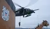 AIR STATION KODIAK, Alaska -- Coast Guard Maritime Security Response Team West members fast-rope from a 210th Rescue Squadron Alaska Air National Guard HH-60G Pave Hawk combat search and resc