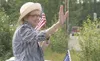 Katie Hurley waves to parade-goers during the Wasilla Fourth of July parade in this 2009 photograph. Hurley rode at the front of the parade as its grand marshal. She is 90 years old. Frontier