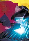 Above, Palmer High School senior Ken Waterer demonstrates the
facility's new wire feed aluminum welder during the opening of the
school district's new welding facility at Colony High School.A