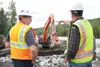 Alaska Rep. Jim Colver (R-Valdez) and DOT employee Craig Logsdon survey a Department of Transportation project to deposit rip-rap to protect the Glenn Highway from the encroaching waters Aug 