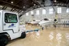 A towing truck operator prepares to move a C-21 from a hangar at Scott Air Force Base, Ill., Aug. 12, 2020. A large storm cell, centered over the base, caused flash flooding over portions of 