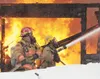 Members of the Central Mat-Su Fire Department spray water on a
blaze Thursday afternoon at a residence on S. Storybook Circle in
Wasilla. The fire broke out shortly after 12 p.m. and appears 