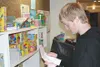 Alexander Warner checks a list twice -- not to see who is
naughty and nice, but to help fill the Christmas wishes of a young
child this holiday season. Warner volunteered Wednesday at the
Spe