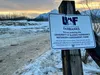 A UAF sign tilts at the entrance to the Kin-Win trailhead parking area at the University of Alaska Fairbanks Matanuska Experiment Farm in Palmer. Amy Bushatz/For the Frontiersman