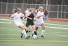 Colony senior Ali Baker splits a pair of defenders during a 2-1 win over West Valley Friday at Eagle River High. Colony moved into the state semifinals with the win. JEREMIAH BARTZ/Frontiersm