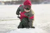 Alex Nelius, 5, peers into his ice fishing hole and waits for a nibble on Finger Lake. ROBERT DeBERRY/Frontiersman file
