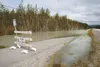 A barricade blocks the bike path along the Old Glenn Highway in the Butte last week where water from the Matanuska River crested its banks and began flooding the area. ROBERT DeBERRY/Frontier