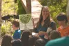 Great Land Trust Mat-Su Program Director Kim Sollien smiles with a piece of student artwork at the Wasilla Creek boardwalk ribbon cutting ceremony on May 12. Sollien recently received the 201