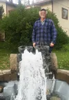 Bill Stokes stands behind the unique fountain he built on his property outside his Wasilla-area home. He managed to complete the task despite massive head injuries suffered in an auto crash a