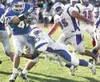 ROBERT DeBERRY/Frontiersman Palmer senior running back John
Scoresby takes a hit from North Pole’s Eric Antesberger.