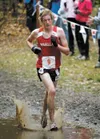 Wasilla Warrior Michael Johnston splashes through the mud on his
way to a third-place finish in the Region III Cross Country
Champion-ships on Saturday at Crevass Moraine Park. ROBERT
DEBERRY