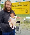Alex King holds his daughter Mikayla at his vendor booth at Friday Fling. Jacob Mann/Frontiersman
