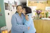 ROBERT DeBERRY/Frontiersman Evelyn Farley kisses friend and
caregiver Diane Jaymes on the cheek, Jaymes made the trip with
Farley from Ohio so she could reunite with her brother whom she has
