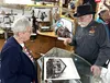 Mat-Su Borough Mayor Edna Devries listens as Jim Huston talks history at the re-dedication of the Willow Historical and Wildlife Museum. Katie Stavick/Frontiersman
