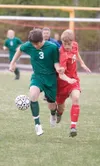 Colony’s Hunter Fisher and Wasilla’s Alden Lee battle for the
ball during Monday’s game at Wasilla High School. ROBERT
DeBERRY/Frontiersman