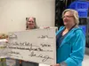 Ola Williams, Director of the Food Pantry, accepts a check from the Matanuska Valley Federal Credit Union, which participated in a fundraising campaign last month. Each branch donates those f