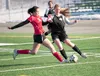 Wasilla’s Keanna Hawk battles with Colony’s Ariana Saxon for the ball during a Colony win over Wasilla Thursday afternoon at Colony High School. ROBERT DeBERRY/Frontiersman.com