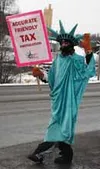 Jake McGuire, aka Lady Liberty, waves to the masses driving
along the Parks Highway. McGuire works for Liberty Tax Service, a
new locally owned Wasilla business. Photo by JEN
RANSOM/Frontiers