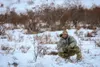 Alaska Army National Guard Sgt. Tristan John, an infantryman from Kwigillingok, with Bison Company, 1st Battalion, 297th Infantry Regiment, stretches a guy rope to ground an arctic 10-man ten