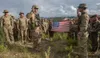 Spc. Eugene Bromberg (left with hand raised), an infantryman, is led in the oath of reenlistment by his commanding officer Army Cpt. Evan Dimakas (right with hand raised) in Poptun, Guatemala