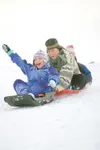 ROBERT DeBERRY/Frontiersman Shelby Irsik, 9, lets out a scream
as she leads Donna and Sally Carr down the sledding hill at
Wonderland Park Thursday morning.