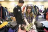 Tommy Ducharme and girlfriend Dakota Bailey look through
clothing Saturday at Burchell High School. The two are expecting a
baby girl any day. Both Bailey and Ducharme are enrolled at
Burchel