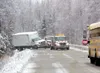 Two Matanuska Towing and Recovery trucks winch a Home Depot
delivery truck out of the ditch near mile 6 of Wasilla-Fishhook
Road Thursday afternoon. Slick conditions caused by falling snow
ca