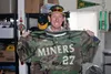 Mat-Su Miners assistant coach Jeff Urlaub holds one of the commemorative Miners jerseys that are part of an auction to benefit the Alaska military. Courtesy of the Mat-Su Miners