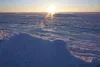 The rising sun lights up the newly frozen Norton Sound sea ice off Nome on winter solstice, Dec. 21, 2018. (Photo by Yereth Rosen/Alaska Beacon)