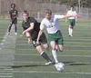 Colony junior Ben Atkinson races down the field past South Anchorage sophomore Luke Twenhafel during the first half of a 3-0 loss to the Wolverines in the boys state championship game Saturda