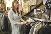 Younique Boutique owner Megan Vincent talks with customers as she prices merchandise in her store in Meta Rose Square in Wasilla. The city council has authorized moving forward with the proce