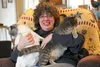 Becky Nichols smiles while her cats Thumper and Winky try to escape. Valley residents have followed Winky’s story since Nichols adopted him from the Mat-Su Borough animal shelter about five y