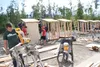 Volunteers chip in to help Jes Seims with his Eagle Scout project, building six outhouses for people whose homes burned during the Sockeye fire. The project was part of a fundraiser in Big La