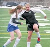 Colony senior Zoe Hixenbaugh, right, tries to move the ball away from Palmer senior Lily Cullers during Colony's 4-0 win over the Moose Wednesday at Colony High. JEREMIAH BARTZ/Frontiersman